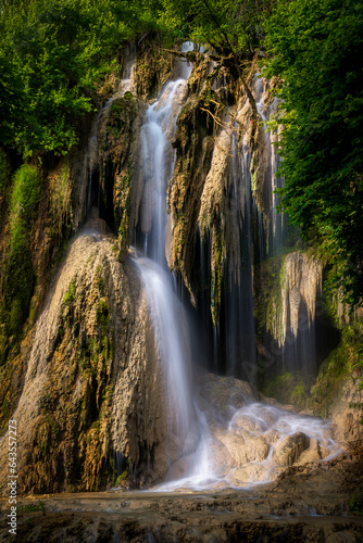 Long exposure image of a waterfall in the forest.