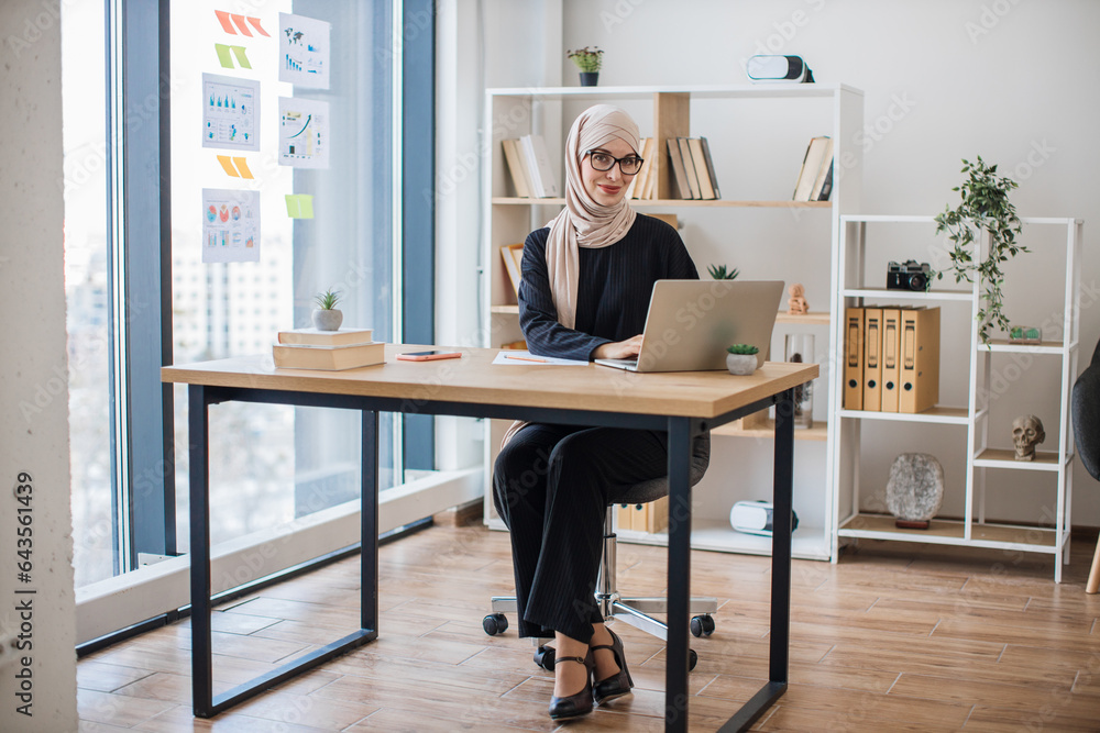 Woman posing behind computer on working day in office Woman posing behind computer on working day in office
