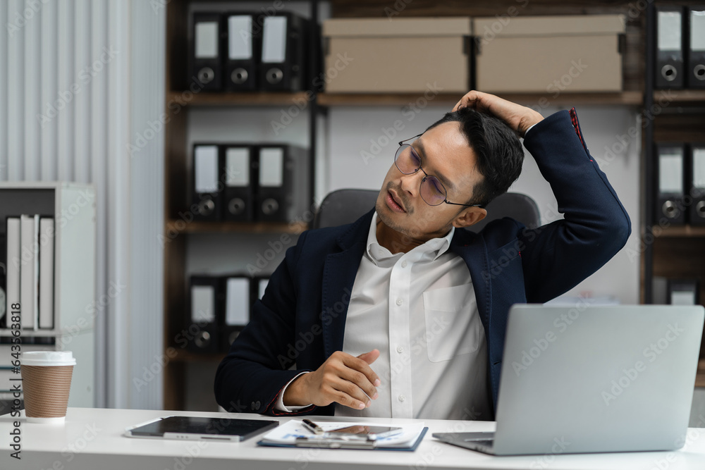 Male businessman is doing a stretchy posture due to sitting in the office for too long, office syndrome concept. Male businessman is doing a stretchy posture due to sitting in the office for too long, office syndrome concept.