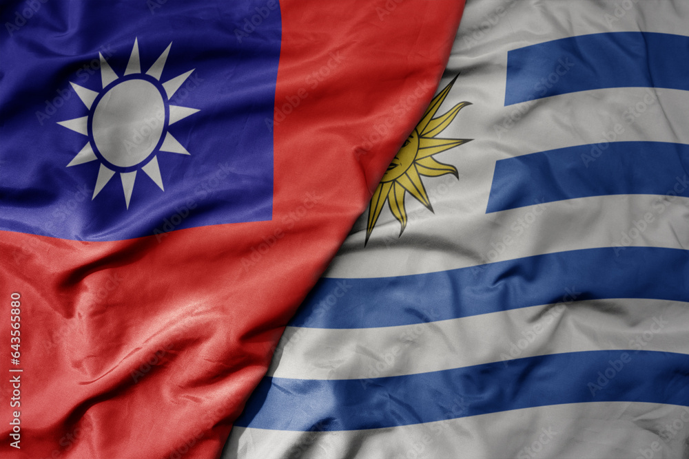 big waving national colorful flag of taiwan and national flag of uruguay .