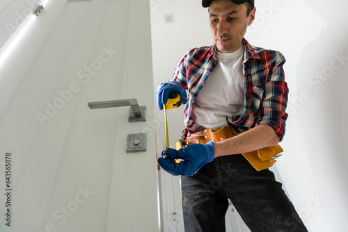 Man installing door architrave repair