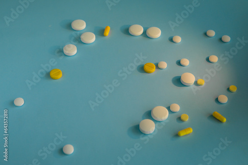 White and yellow tablets on a blue background