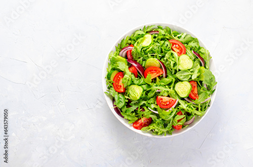 Healthy Vegetable Salad with Tomatoes, Arugula, Cucumbers and Onion, Diet Menu, Bright Background