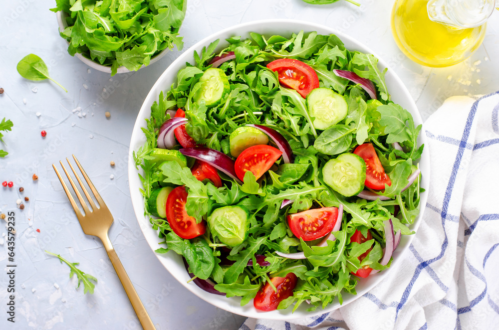 Healthy Vegetable Salad with Tomatoes, Arugula, Cucumbers and Onion, Diet Menu, Bright Background Healthy Vegetable Salad with Tomatoes, Arugula, Cucumbers and Onion, Diet Menu, Bright Background