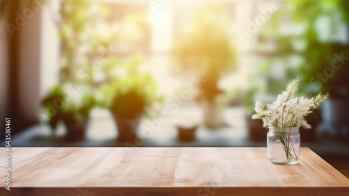 Fototapeta Naklejka Na Ścianę i Meble -  Wooden table with a clear vase by the window against a blurred background of the sunlight garden background. High quality photo
