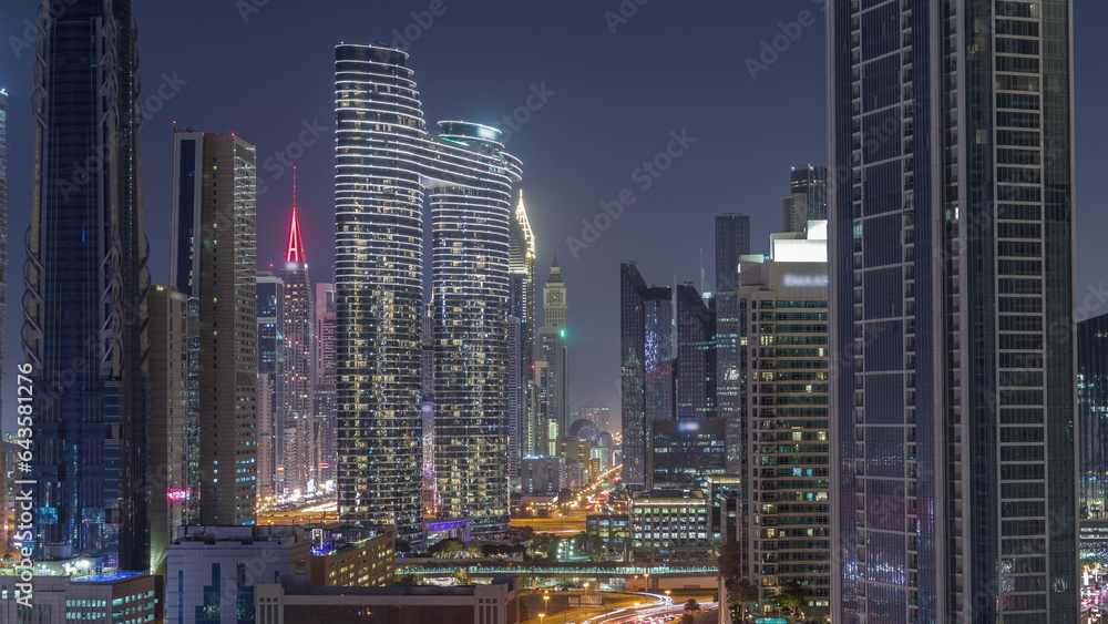 Many towers and skyscrapers with traffic on streets in Dubai Downtown and financial district night timelapse. Many towers and skyscrapers with traffic on streets in Dubai Downtown and financial district night timelapse.