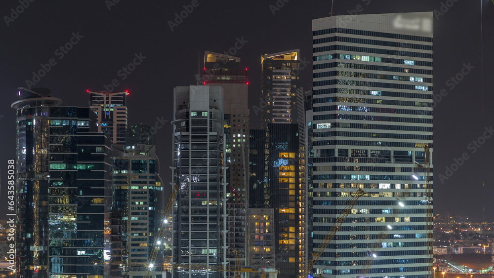 Obraz premium Cityscape with skyscrapers of Dubai Business Bay and water canal aerial night timelapse.