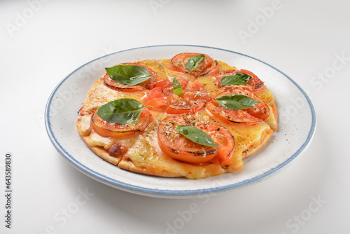 baked hot vegetarian margherita and tomato basil cheese round pizza in plate on white table western vegetarian pastry cuisine halal food hotel luxury cafe menu