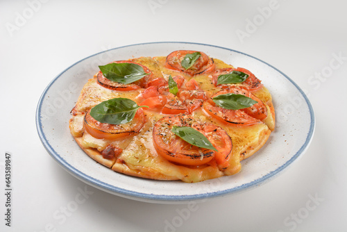 baked hot vegetarian margherita and tomato basil cheese round pizza in plate on white table western vegetarian pastry cuisine halal food hotel luxury cafe menu
