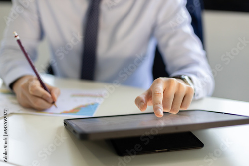 Businessman working using digital tablet at table office. male searce internet information connection and send message. photo