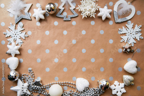 Christmas silver frame: ornaments background, basic classic pattern, place for text. Trendy decorations: disco balls, snowflakes, fluffy ornaments. Aesthetic festive atmosphere. View from above