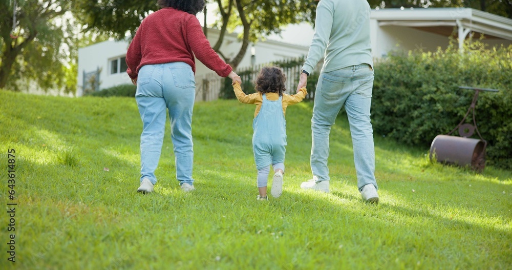 Fototapeta premium Family, walking and parents support a child in a backyard bonding by a home or house for care or love for a holiday. Outdoor, mother and father enjoying quality time and playing with kid in back view