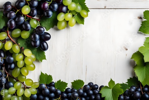 Bunch of green and purple grapes on wooden background with copy space . photo