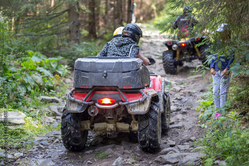 ATV on the mountain road in forest causing erosion problem for environment