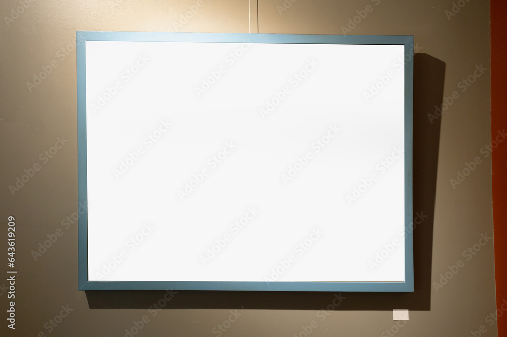 Blank picture frames on brown wall with glowing lamp, mock up Blank picture frames on brown wall with glowing lamp, mock up
