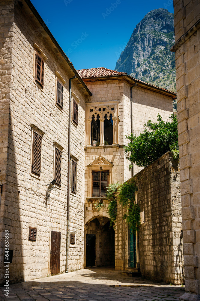 Fototapeta premium Beautiful old buildings on the cozy street of Kotor old town, Boka Kotor bay