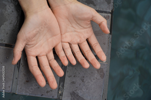 wrinkled hand because of soak in the water for a long time,hands withered from prolonged soaking in water