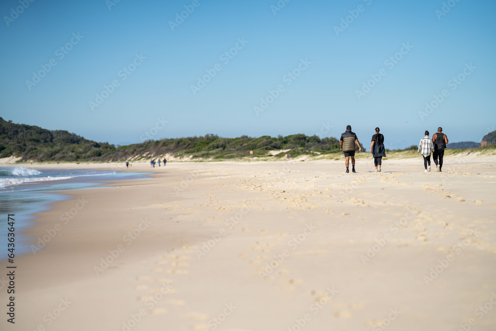 walking on the beach at dusk on an australian sandy beach