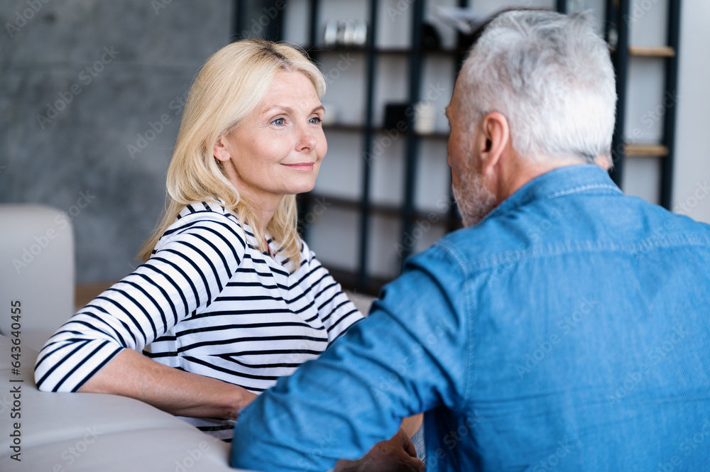 Middle age woman having pleasant conversation with man Middle age woman having pleasant conversation with man