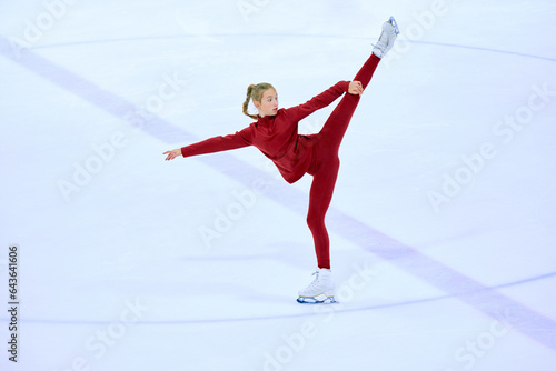 Photography Talented, artistic and concentrated girl, figure skating athlete in motions, training on ice rink arena