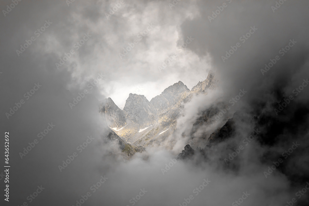 Fototapeta premium mountain peaks in dense clouds