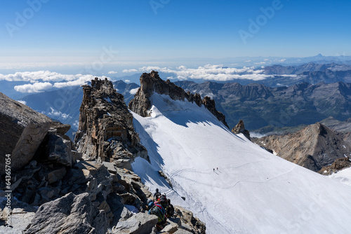 Mountaineers climbing Gran Paradiso glacier to the summit of the mountain. Gran Paradiso National Park, Italian Alps.