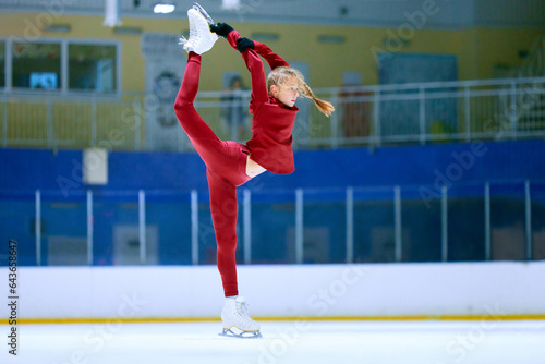 Talented, flexible girl in motion, figure skating athlete in red sportswear training on ice rink arena. Championship preparation. Concept of professional sport, competition, sport school, hobby, ad