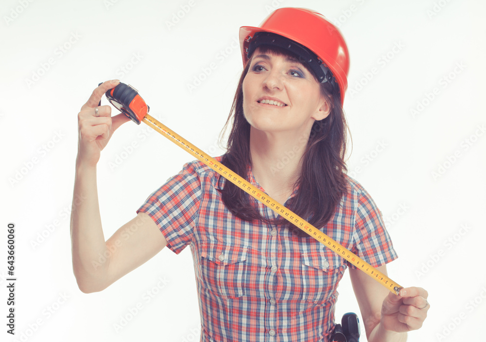 Happy builder woman in red helmet holding tape measure. Engineering Happy builder woman in red helmet holding tape measure. Engineering