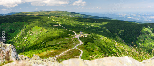 Fototapeta Naklejka Na Ścianę i Meble -  Giant Mountains, mountain panorama from the hiking trail to the top of Sniezka. View of the vast mountain slopes and trails on a sunny summer day.
