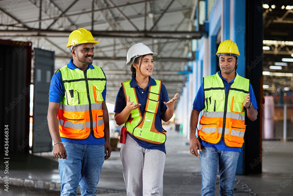 factory workers walking and talking about work or project in the warehouse storage factory workers walking and talking about work or project in the warehouse storage