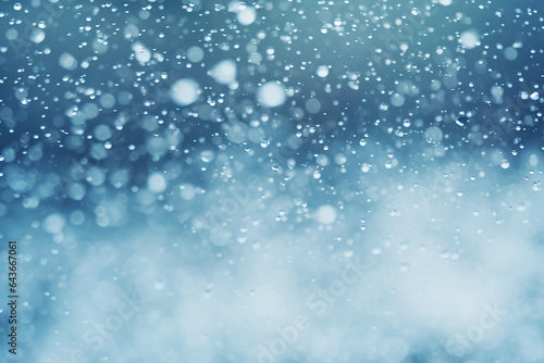 Light blue bokeh effect from snow and raindrops, background photo