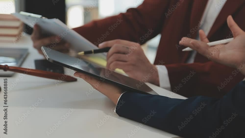 Justice and law concept.Male judge in a courtroom with the gavel, working with, computer and docking keyboard, eyeglasses, on table in morning light Justice and law concept.Male judge in a courtroom with the gavel, working with, computer and docking keyboard, eyeglasses, on table in morning light