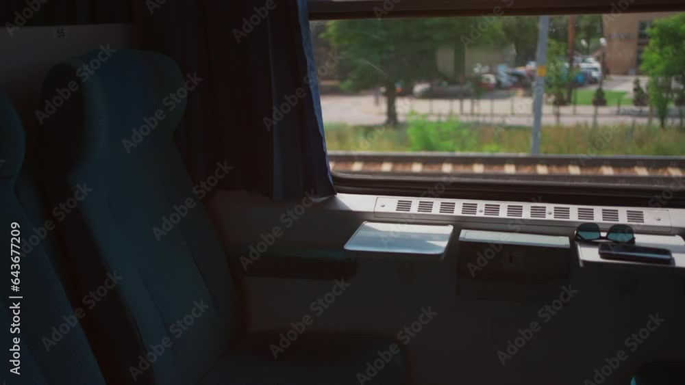 train window and chair, speed railway, green trees outside train window and chair, speed railway, green trees outside