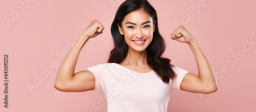 Asian woman posing on pink ...