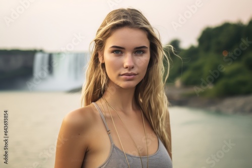 Headshot portrait photography of a merry girl in his 20s wearing an elegant halter top at the niagara falls in ontario canada. With generative AI technology