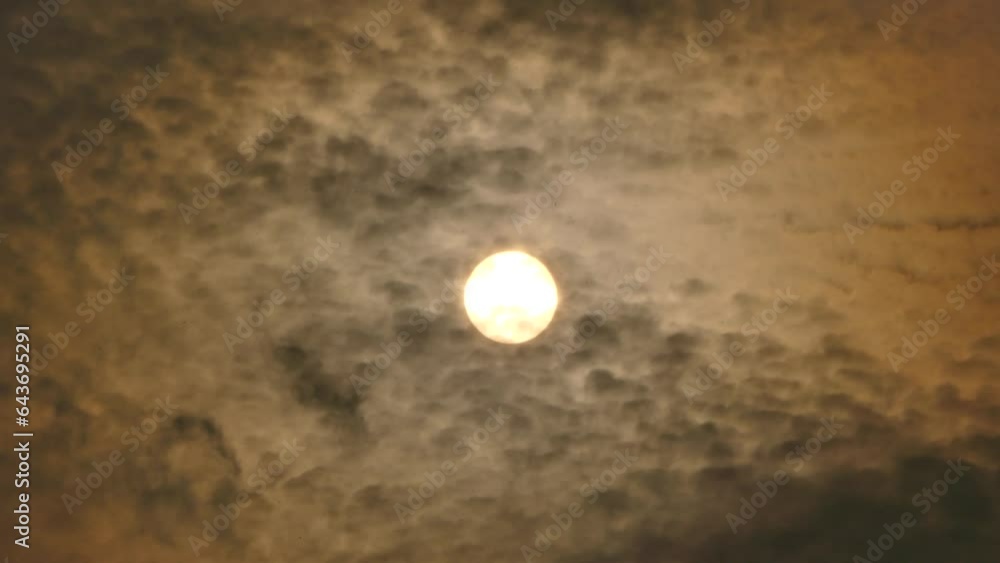 Evening orange and grey sky with moving clouds and sun during rainfall - real time. Topics: weather, meteorology, climate, sun energy Evening orange and grey sky with moving clouds and sun during rainfall - real time. Topics: weather, meteorology, climate, sun energy