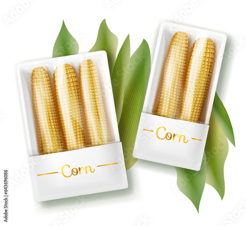 Ready to cook corn cobs in plastic packs with green leaves on the background isolated on white.
