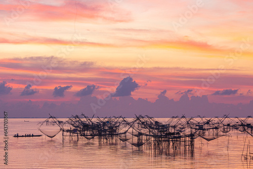 Amazing colorful sky at twilight above fishing trap at Pakpra..fisherman catching fish by square dip net  at Pak Pra canal in Talay Noi  Phatthalung..fishing trap in beautiful sky background. photo