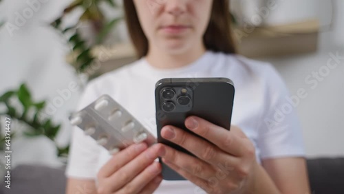 Selective focus of young woman using smartphone for searching online information about prescription pills label text about medical information online, instructions side effects, pharmacy medicament photo