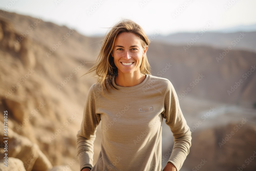 Full-length portrait photography of a happy girl in her 40s wearing a long-sleeved thermal undershirt at the masada in southern district israel. With generative AI technology Full-length portrait photography of a happy girl in her 40s wearing a long-sleeved thermal undershirt at the masada in southern district israel. With generative AI technology