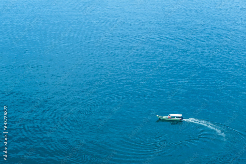 Fishing boat traveling in the beautiful blue sea. Fishing boat spinning