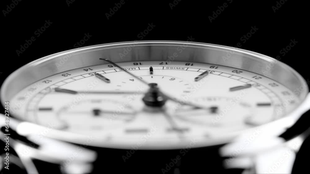 Second arrow running on the black clockface of luxury swiss watch with chronograph. Light flash on the turning clockface. Closeup real time shot. Running second arrow Second arrow running on the black clockface of luxury swiss watch with chronograph. Light flash on the turning clockface. Closeup real time shot. Running second arrow