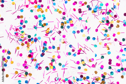 Fototapeta Naklejka Na Ścianę i Meble -  Colorful glitter sparkle confetti background liquid drops of paint color flow down on white canvas. Dark multicolored glitter paint dripping on the white wall