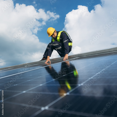 Service engineer checking solar cell on the roof for maintenance if there is a damaged part. Engineer worker install solar panel. Clean energy concept.