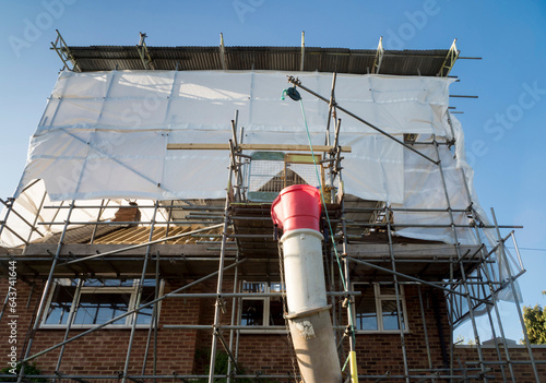 Obraz na płótnie Europe, UK, England, Surrey, scaffolding tin hat on house roof renovation w salonie