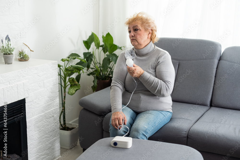 Sick senior woman has a viral infection or flu, labored breathing, asthma. An elderly female is