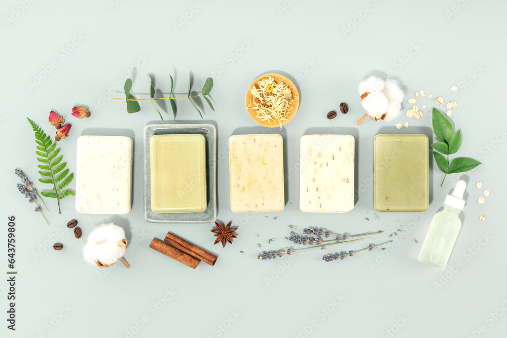Bars of natural handmade soap and ingredients on blue background, top view banner - obrazy, fototapety, plakaty 
