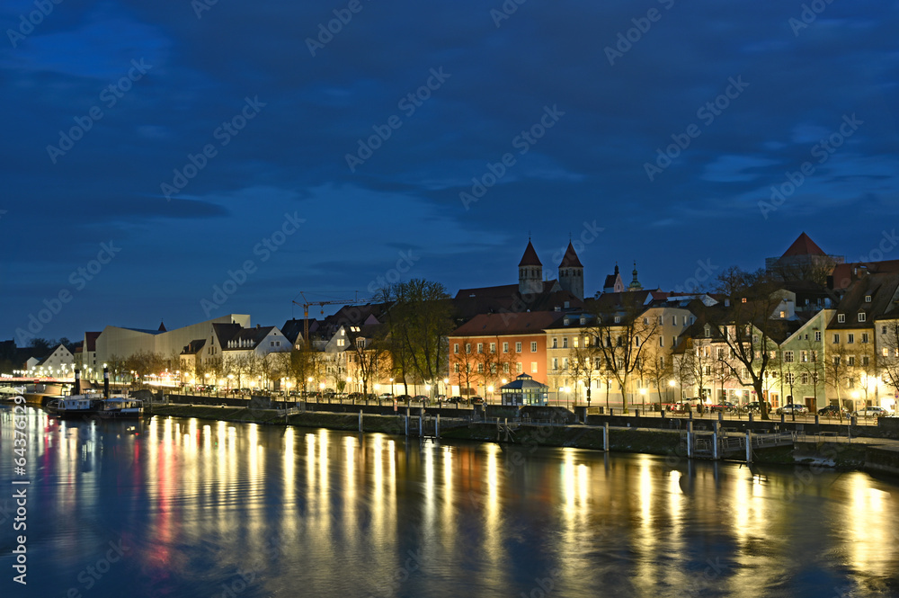Beautiful old buildings and Danube river at night in Regensburg Germany