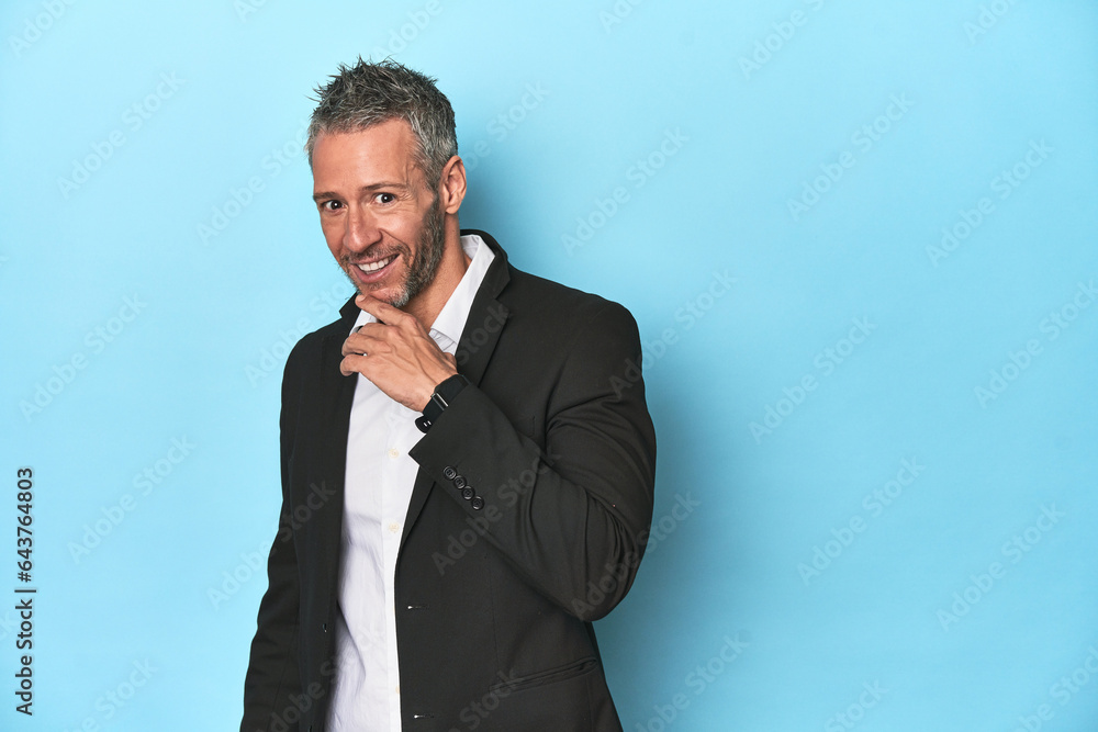 Businessman in formal attire on blue studio background Businessman in formal attire on blue studio background