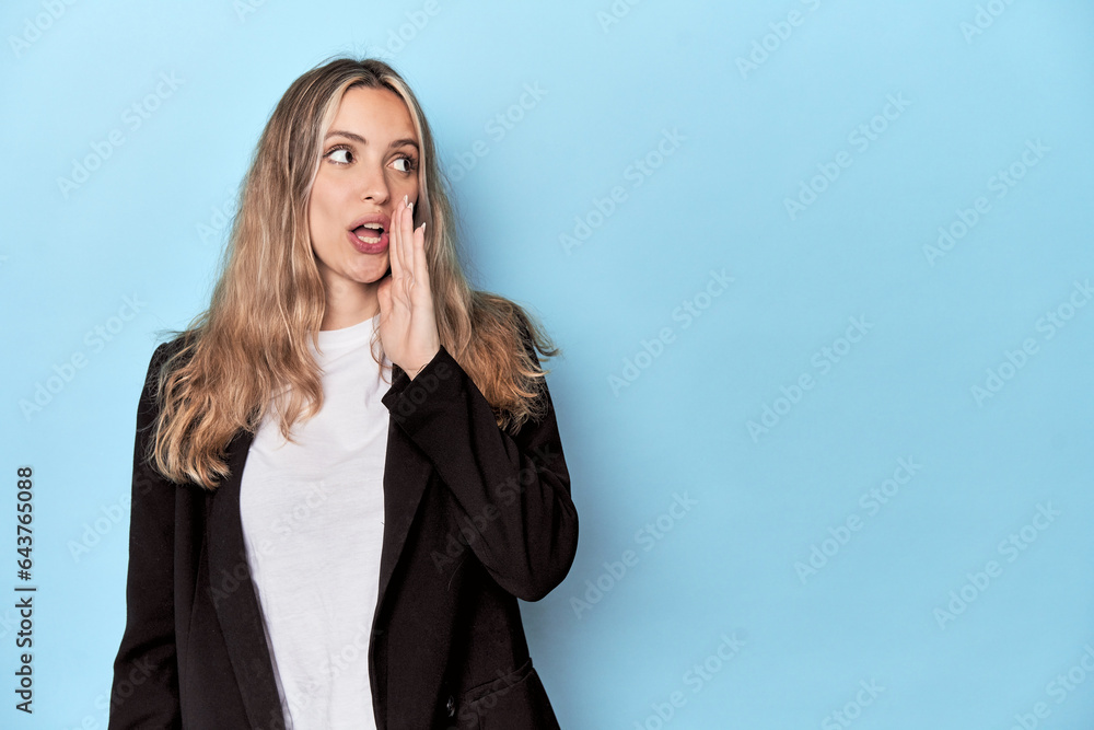 Caucasian woman in business jacket is saying a secret hot braking news and looking aside Caucasian woman in business jacket is saying a secret hot braking news and looking aside